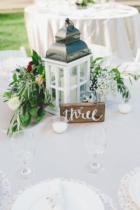 lantern and painted wooden table number wedding reception centerpiece via one love photography