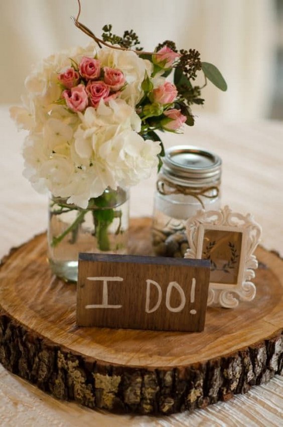 rustic tree stump and mason jar wedding centerpiece