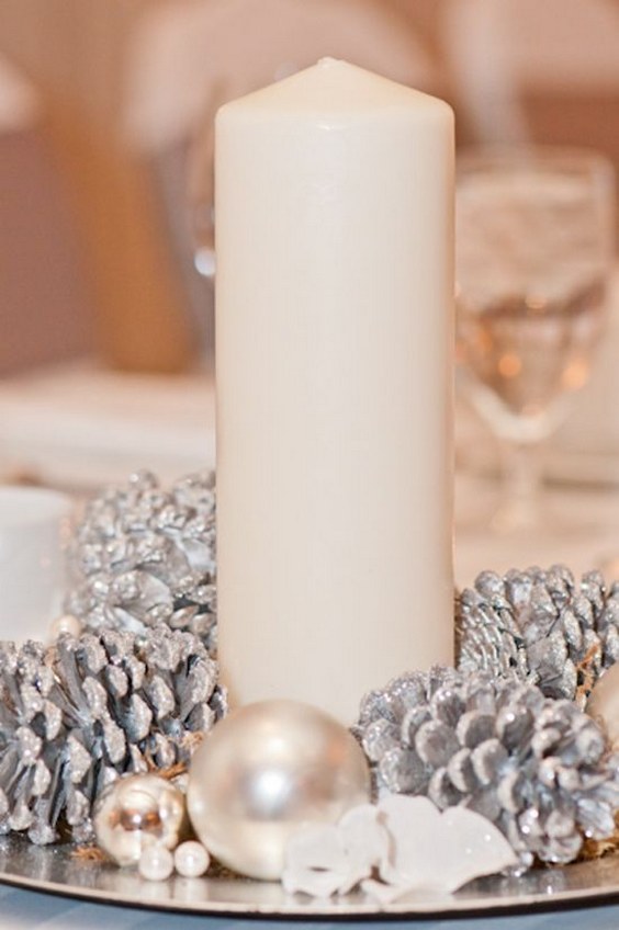 winter candle and pinecone wedding centerpiece