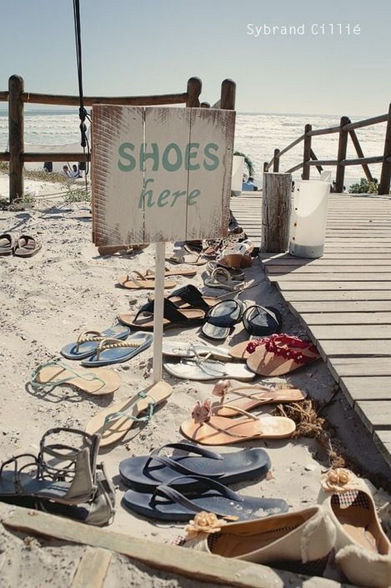 40 Fun and Easy Beach Wedding Ideas for 2024 22 beach wedding detail shoes here sign