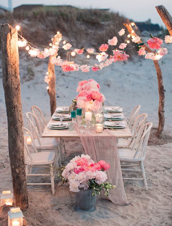 flower garland tablescape and string lights beach wedding decor
