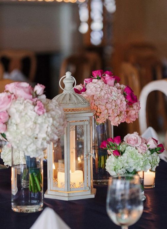 pink flowers and vintage lantern wedding reception centerpiece idea via kk photography