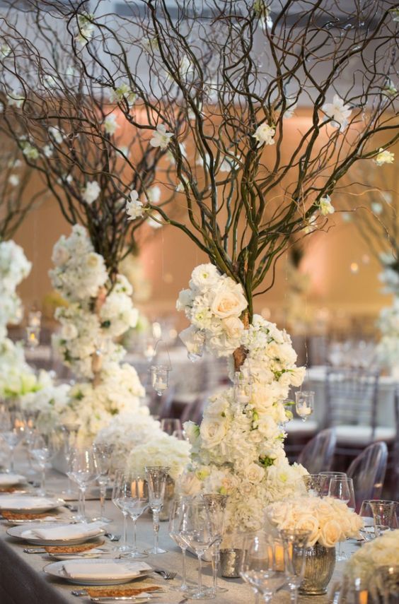 rustic white flowers tall winter wedding centerpiece idea via john cain photography