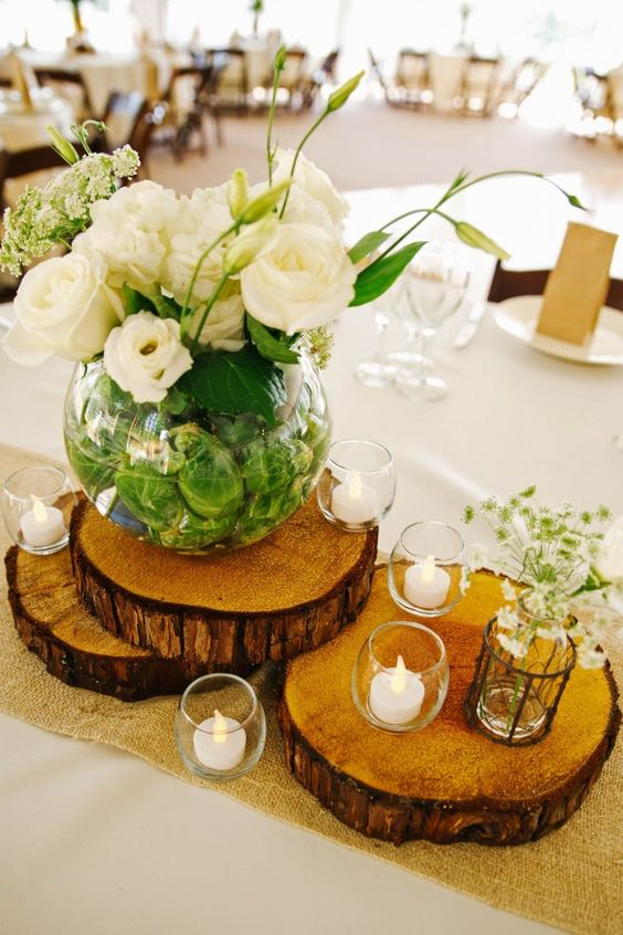 rustic wood stump and white flowers wedding centerpiece