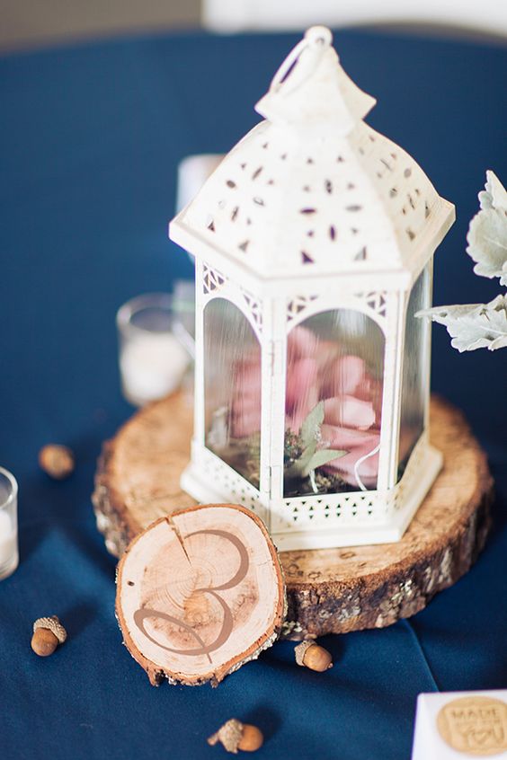 white lantern centerpiece with wood cut table number