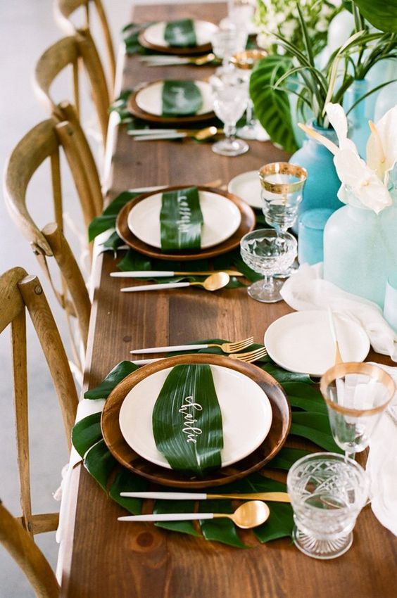 tropical tablescape with calligraphy on leaves by kindred creations via kristamason