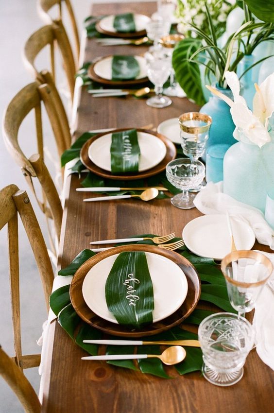 30 Tropical Leaf Greenery Wedding Decor Ideas 5 tropical tablescape with calligraphy on leaves by kindred creations via kristamason