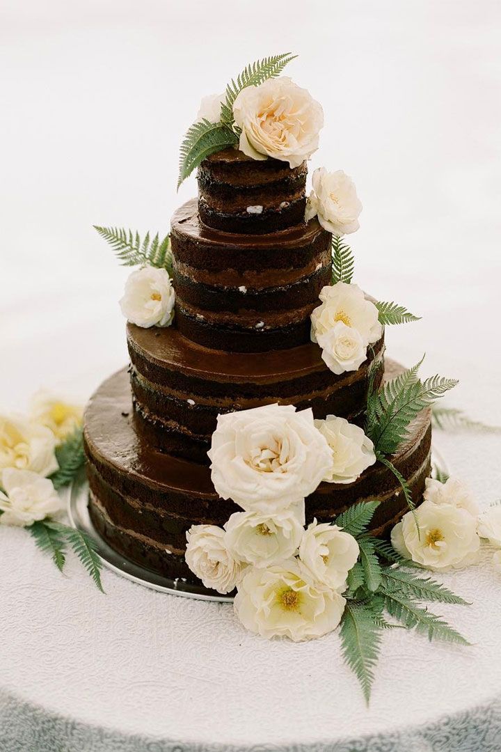 4 tier naked chocolate wedding cake with white flowers