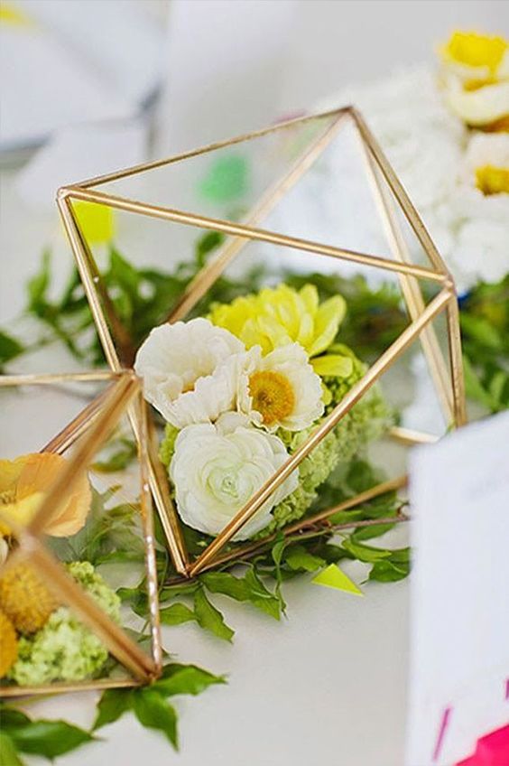 Fill up gilded prisms with florals or candles for captivating center pieces