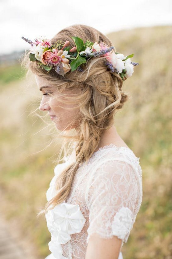 Messy braid wedding hairstyle with colorful flower crown