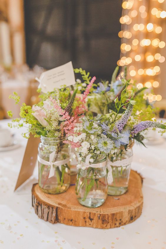 Rustic English country garden flowers in jars for the wedding breakfast