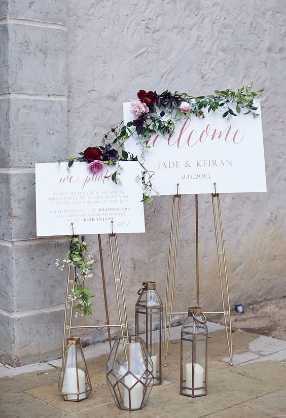 geometric candle lanterns and copper stands for signage