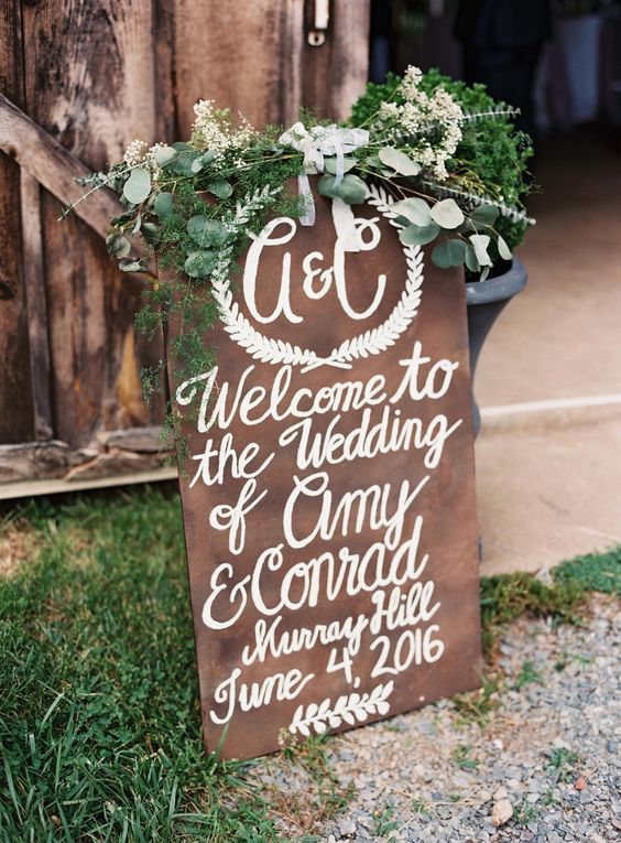 rustic wedding sign with greenery decor