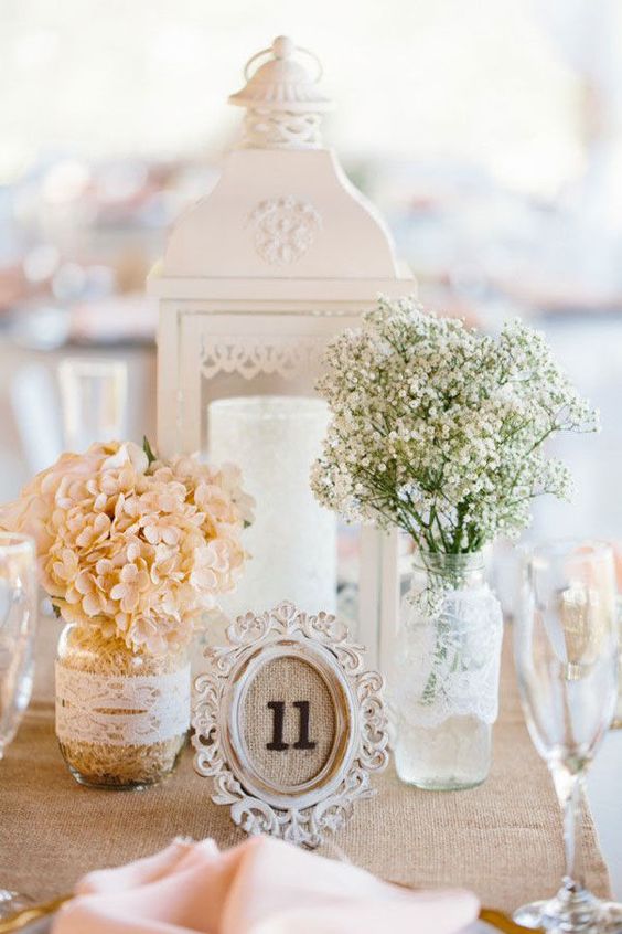 vintage centerpiece with baby's breath in lace wrapped jar and burlap framed table number