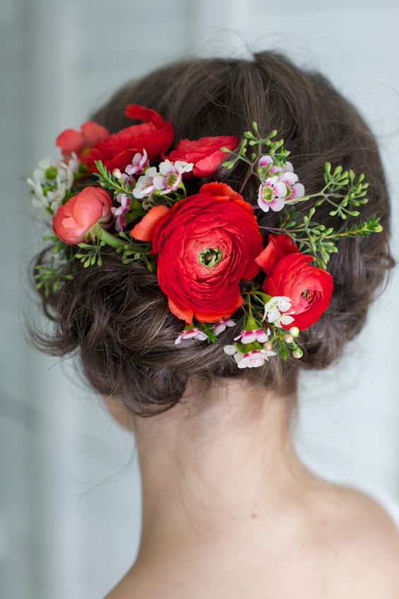 wedding updo hairstyle with red flowers