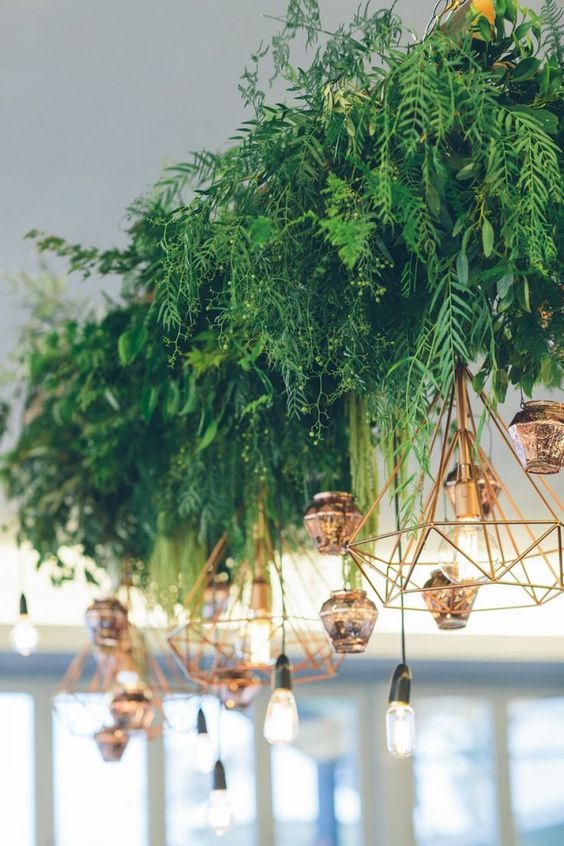 Hanging foliage and geometric lighting wedding decor