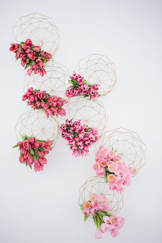 Shades of pink wedding inspiration with geometric designs as vessels bursting with tulips