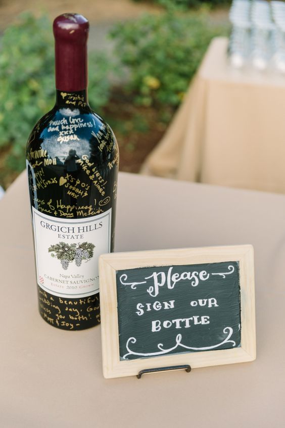 a bottle of wine wedding guest sign