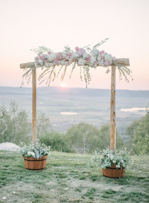 Bamboo wedding arch with pink and white flowers via Andy Barnhart