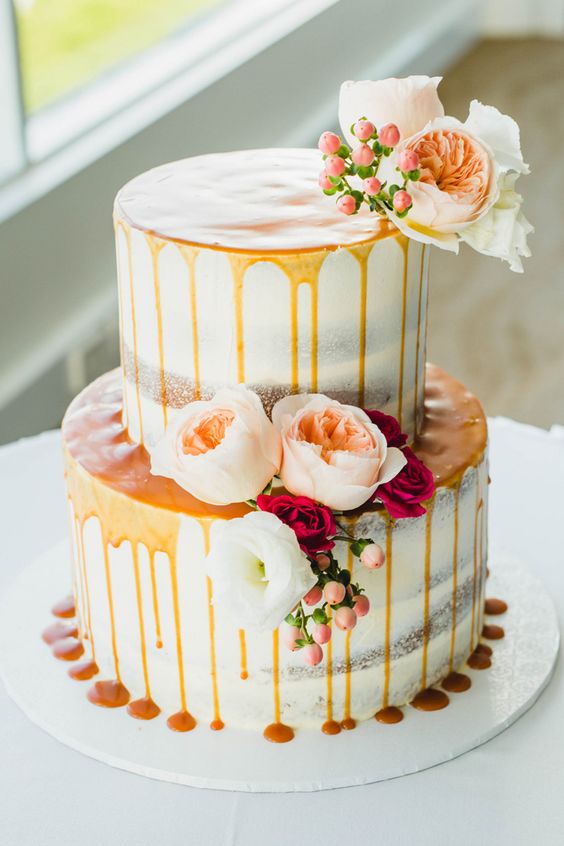 Caramel drip two tier wedding cake with peach roses via Curly Tree Photography