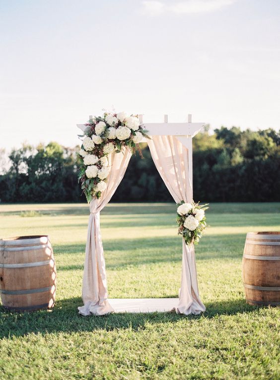 Floral Draped Ceremony Arch in Wine Country via Michael and Carina Photography