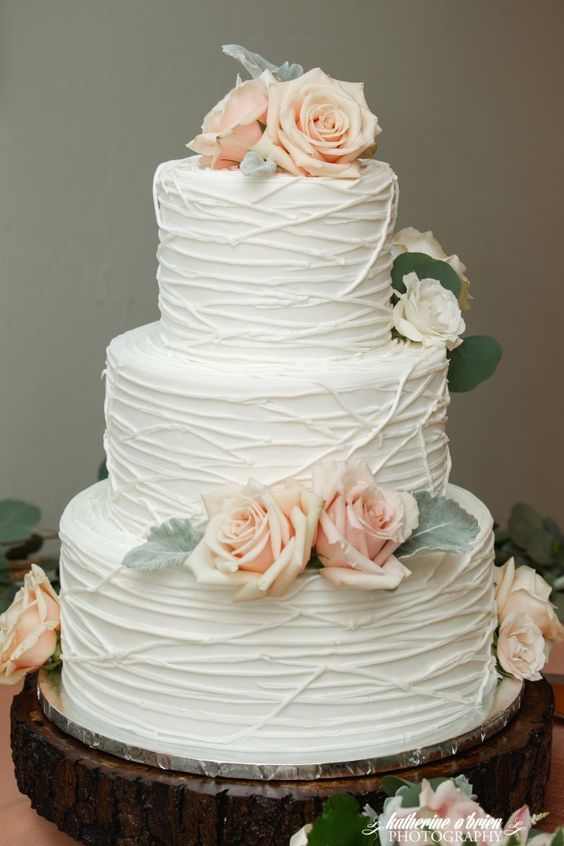 Rustic chic white lined texture wedding cake accented with pink roses via Katherine O’Brien Photography