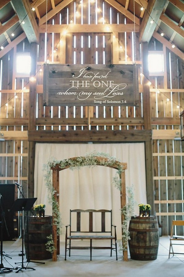 barn wedding rustic ceremony with wine barrel and arch with baby breath jennifer van elk photography