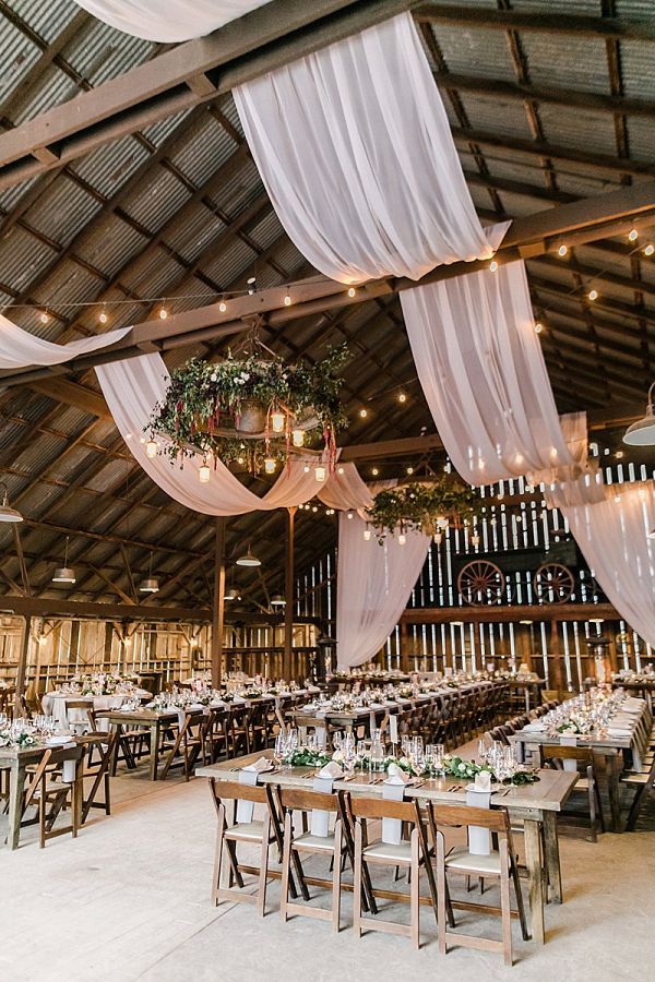 rustic country greenery barn wedding reception decor with draping fabric