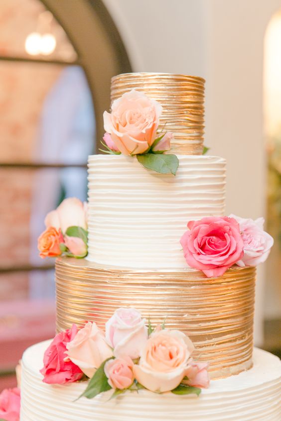 Gold + white rose topped wedding cake via Amalie Orrange Photography