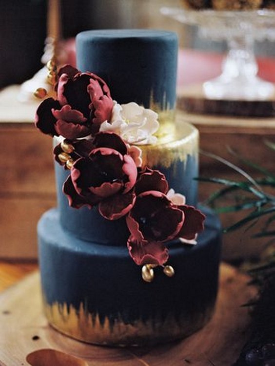 navy fondant cake with metallic gold and berry colored flowers