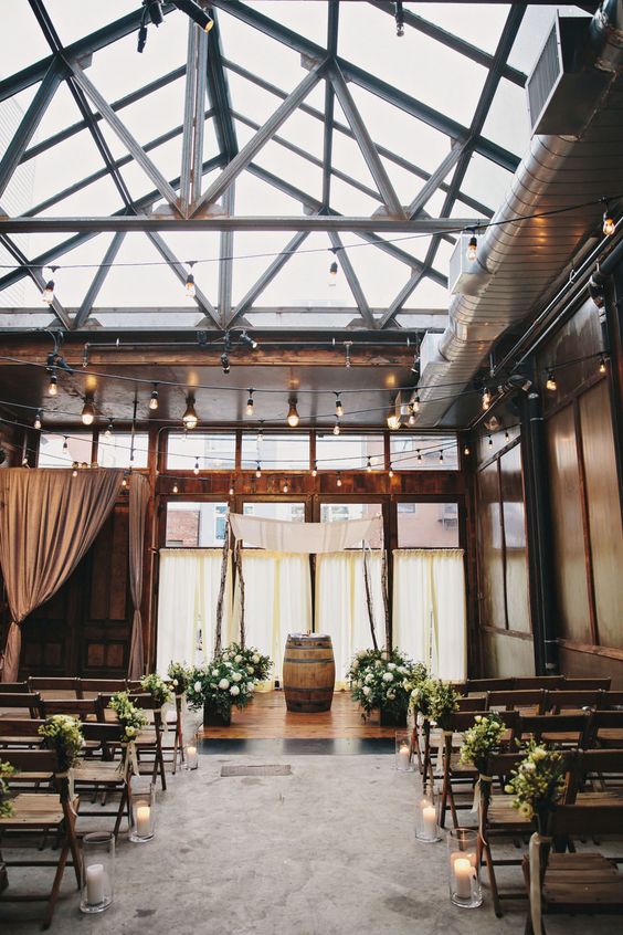 rustic country industrial greenery and wine barrel wedding arch