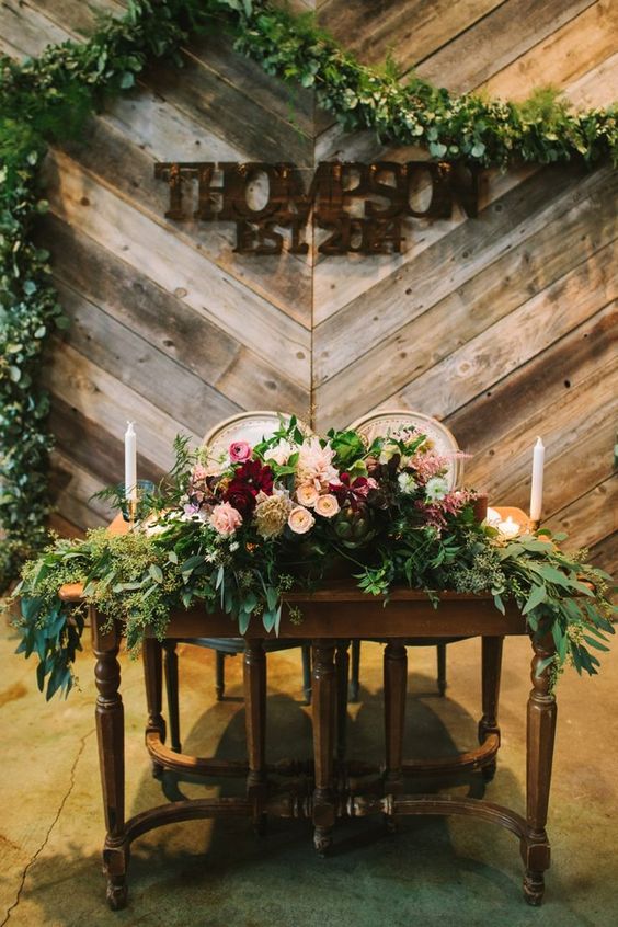 rustic sweetheart table overflowing with flowers