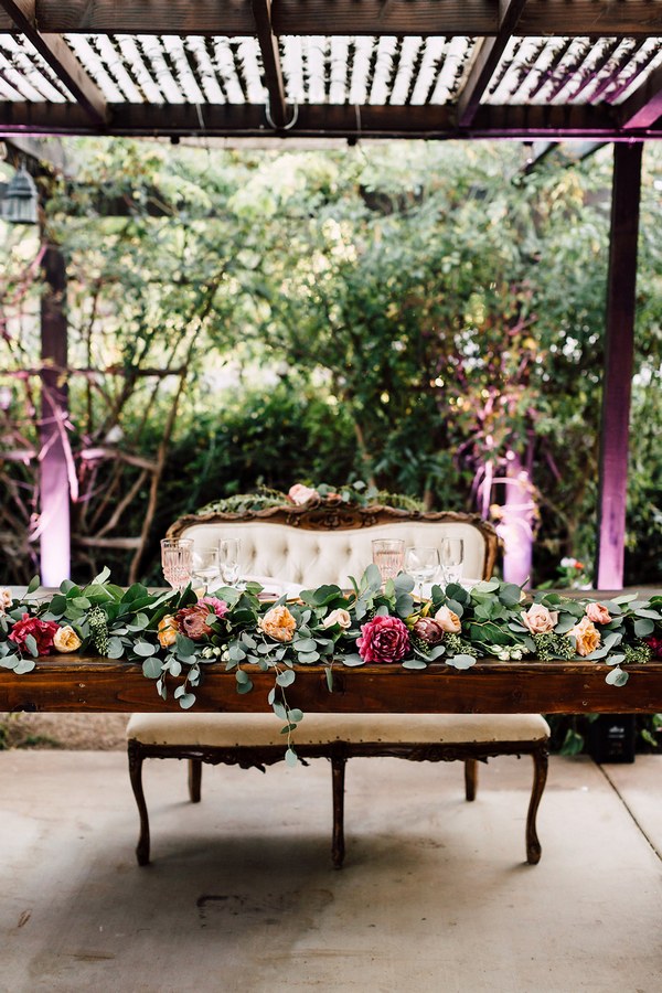 rustic burgundy and greenery sweetheart table decor