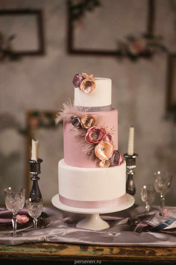 Dusty pink, mauve, pale rose wedding cake with feathers and silk flowers