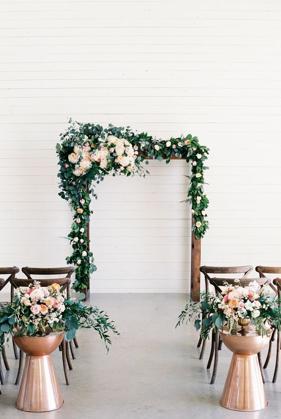 copper and greenery indoor wedding arch