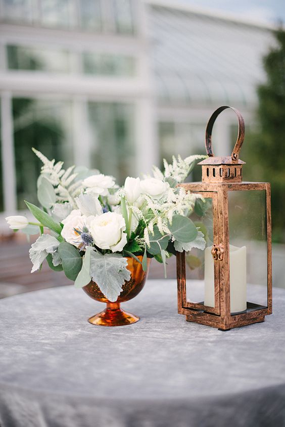 copper lantern and greenery wedding centerpiece