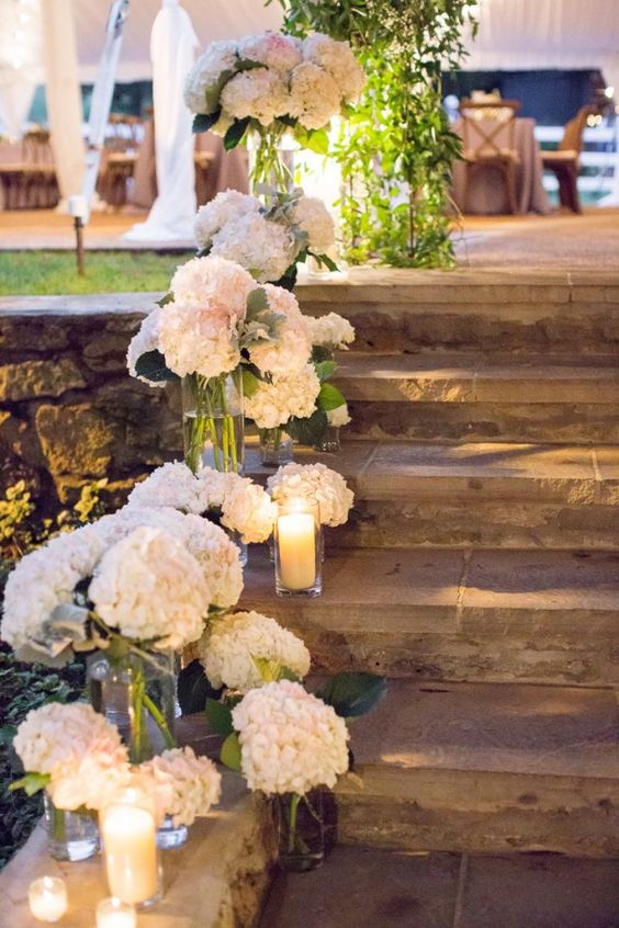 Reception stairwell lined with white hydrangeas
