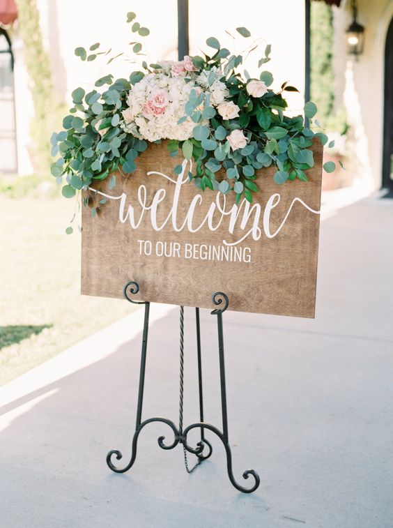 Rustic eucalyptus and peony topped wedding sign