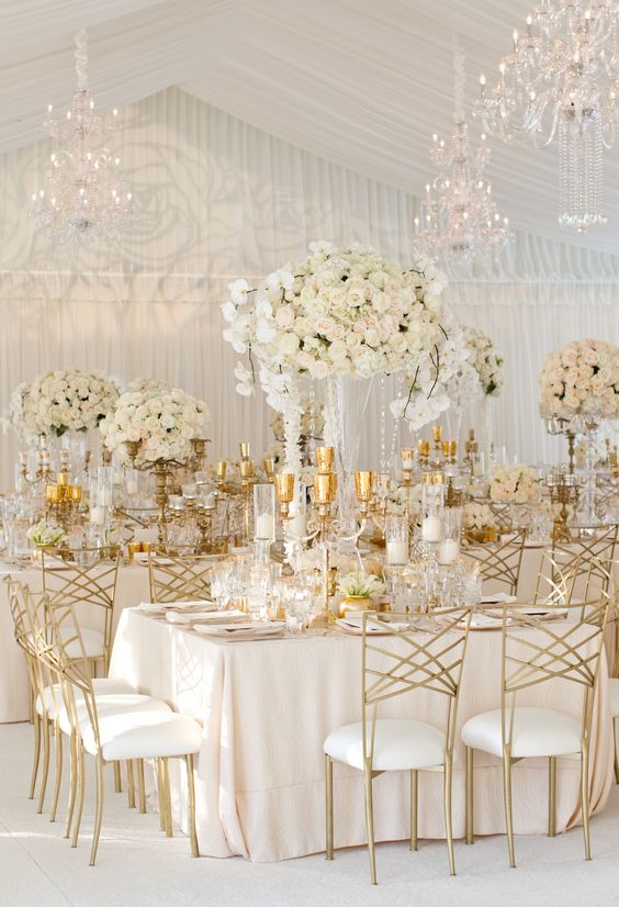 covered with soft blush linens and lush arrangements of ivory florals dripping with crystals