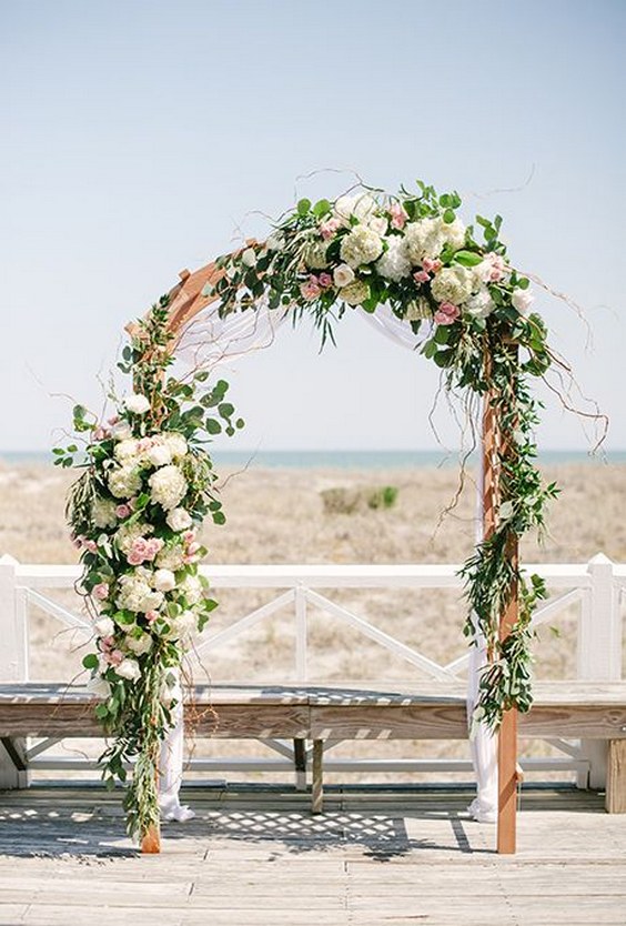 floral-covered wedding arch