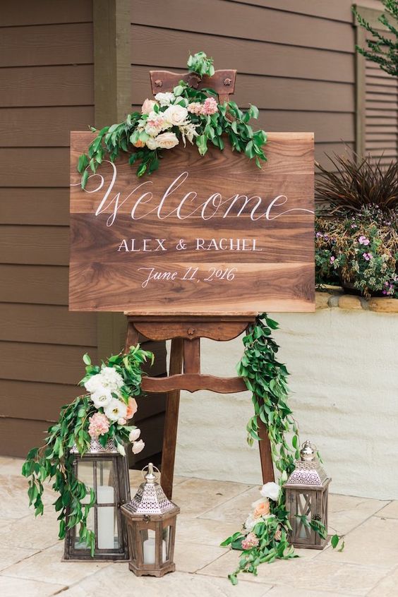 rustic greenery and lantern welcome wedding sign