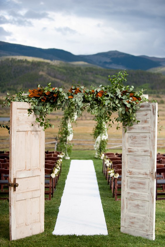 rustic old door and greenery wedding entrance