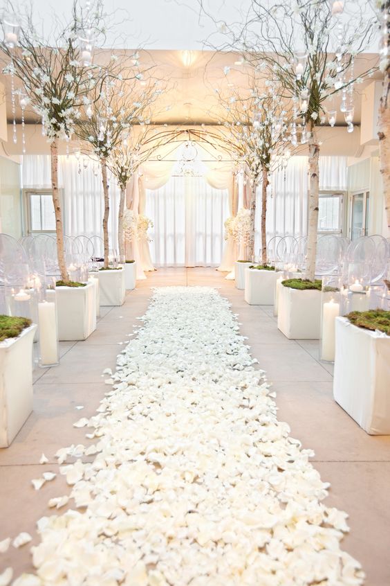 wedding aisle of white rose petals and branches dripping with crystals