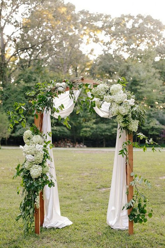 white hydrangea and greenery wedding arch