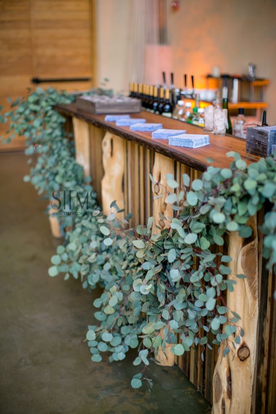 Garlands of silver dollar eucalyptus wedding bar decor ideas