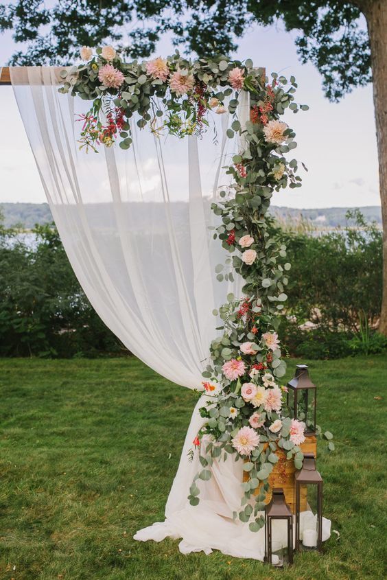 Romantic Ceremony arbor with fabric and eucalyptus garland and cafe au lait dahlias and rose
