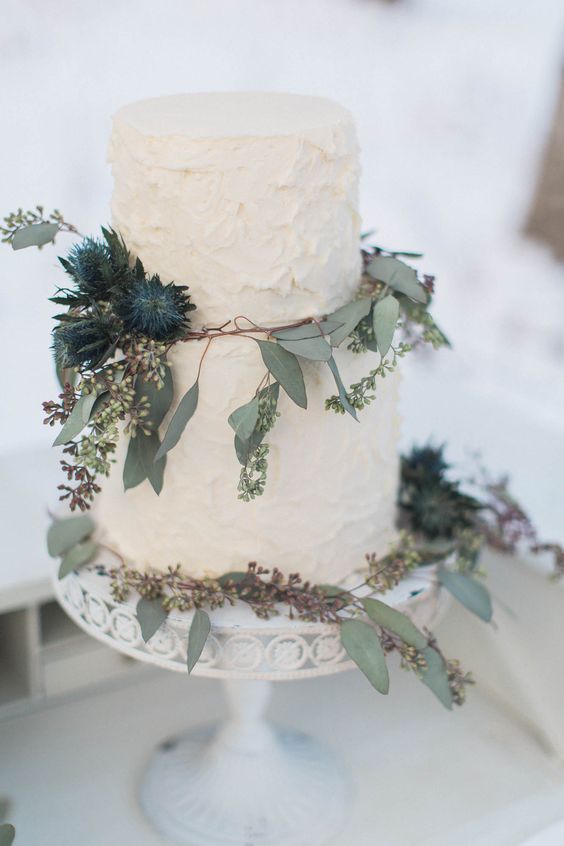 Simple white buttercream cake with eucalyptus greens