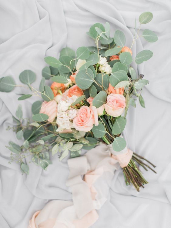 Whimsical peach roses and eucalyptus wedding bouquet