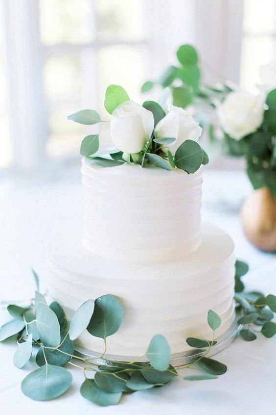 modern white and eucalyptus wedding cake