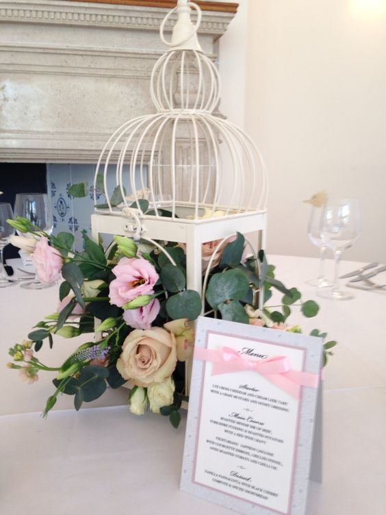 Birdcage centrepieces at Coombe Lodge with flowers by Daisy Lane Floral